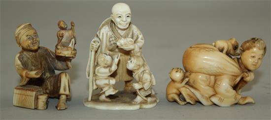 A Japanese ivory netsuke and two similar okimono